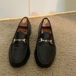 Men’s black loafers with gold hardware